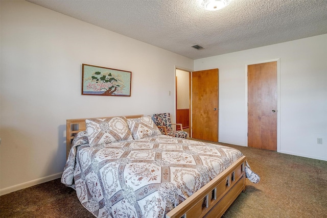 bedroom featuring a textured ceiling, a closet, and dark carpet