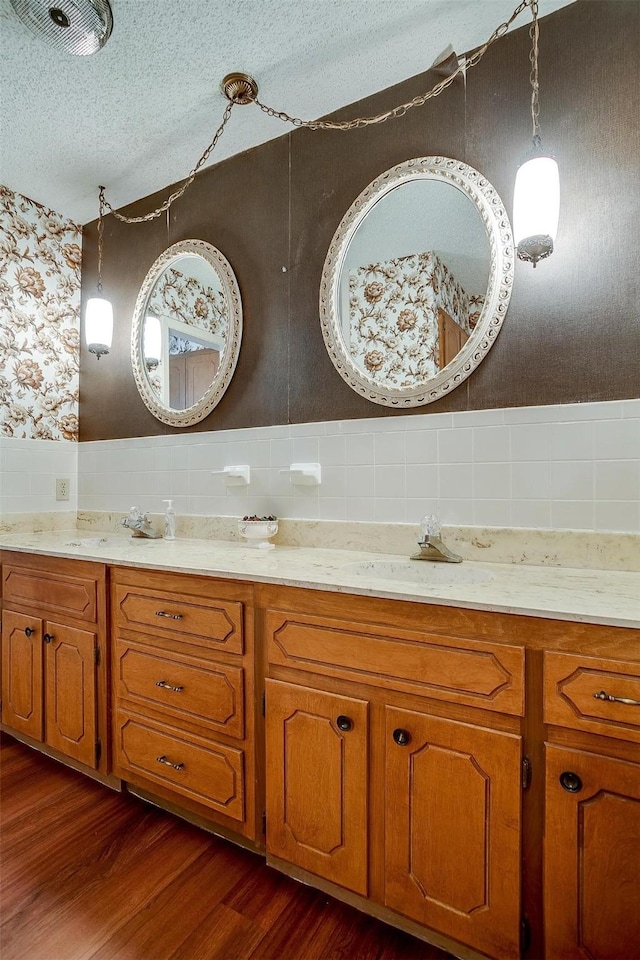 bathroom featuring hardwood / wood-style flooring, a textured ceiling, and vanity