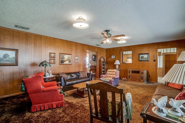 living room featuring carpet and ceiling fan