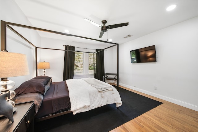 bedroom with ceiling fan and wood-type flooring