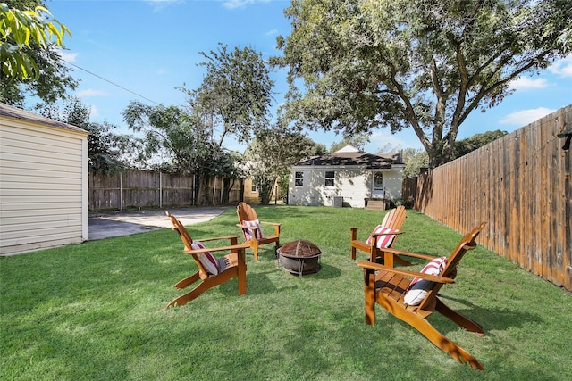 view of yard featuring an outdoor fire pit and an outdoor structure