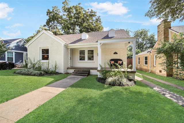 view of front of house featuring a front yard and covered porch