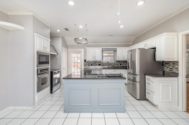 kitchen featuring white cabinets, appliances with stainless steel finishes, sink, and a kitchen island