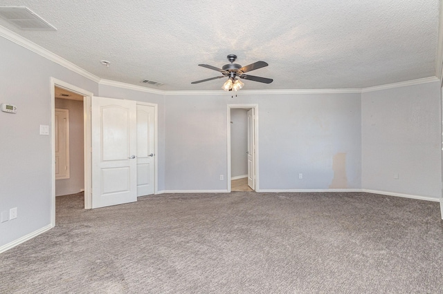 spare room with ceiling fan, light colored carpet, a textured ceiling, and crown molding