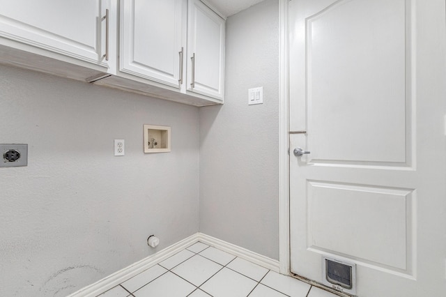 washroom featuring cabinets, electric dryer hookup, hookup for a washing machine, light tile patterned floors, and gas dryer hookup