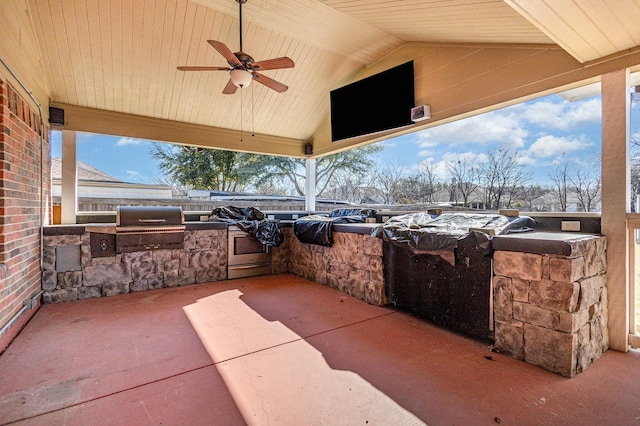 view of patio featuring exterior kitchen, grilling area, and ceiling fan