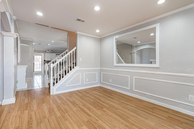 unfurnished room featuring light hardwood / wood-style floors and ornamental molding