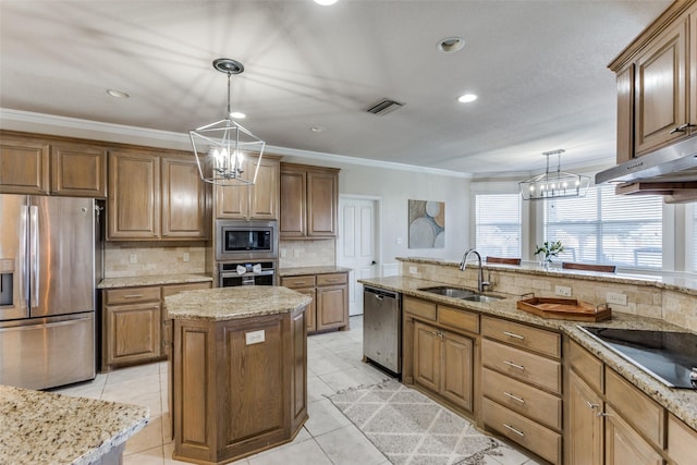 kitchen with sink, decorative light fixtures, a center island, and appliances with stainless steel finishes