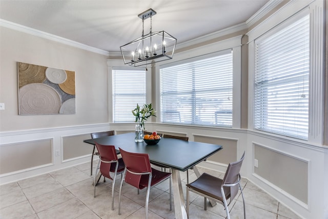 tiled dining room with a chandelier and ornamental molding