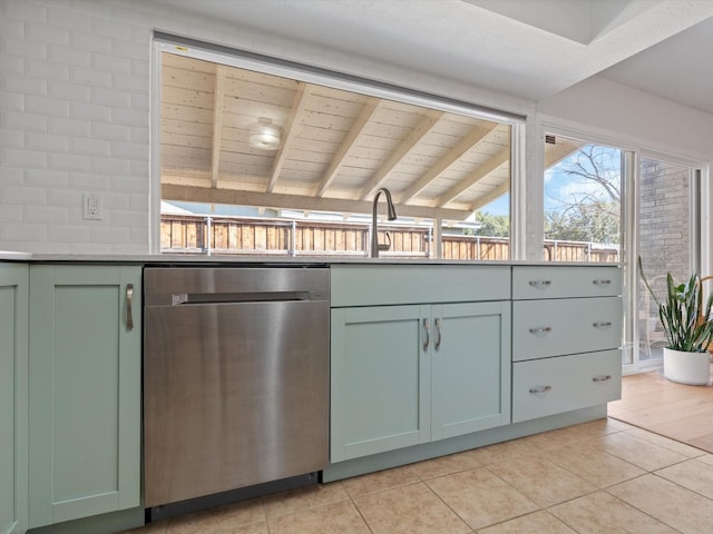 kitchen with dishwasher, sink, backsplash, light tile patterned floors, and green cabinetry