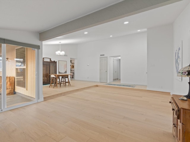 living room featuring an inviting chandelier and light hardwood / wood-style floors