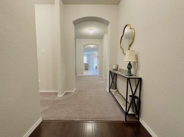 corridor with hardwood / wood-style flooring