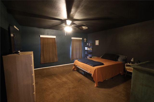 bedroom with ceiling fan and dark carpet