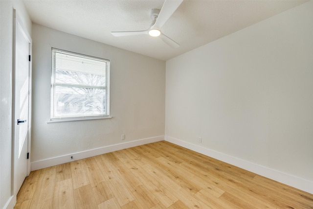 spare room with ceiling fan and light wood-type flooring