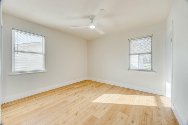 empty room featuring ceiling fan, light hardwood / wood-style floors, and a healthy amount of sunlight