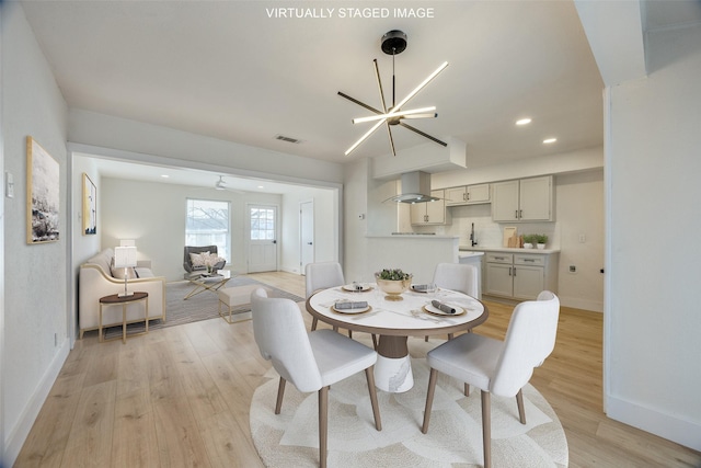 dining room featuring a chandelier and light hardwood / wood-style flooring