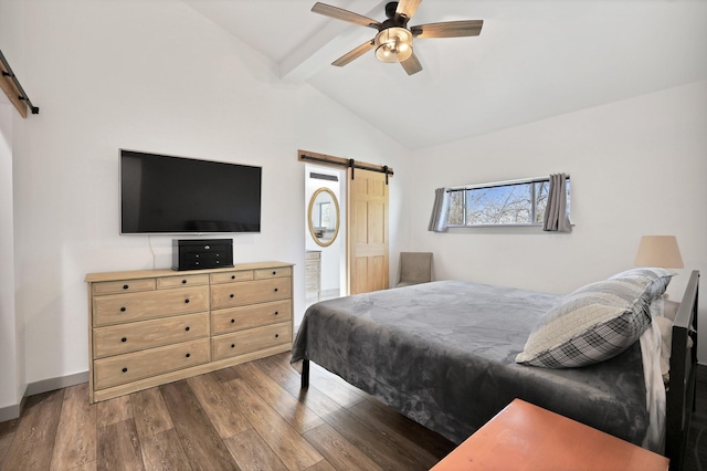 bedroom with ceiling fan, a barn door, dark wood-type flooring, and vaulted ceiling with beams