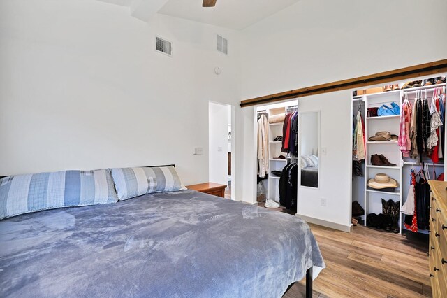 bedroom with vaulted ceiling, ceiling fan, and light hardwood / wood-style floors