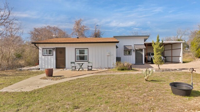 exterior space featuring a front lawn and a carport