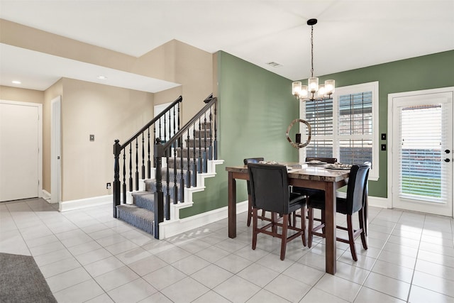 tiled dining space featuring a chandelier