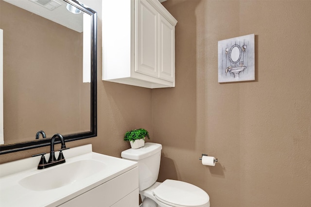 bathroom with toilet and vanity