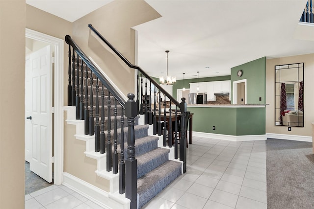 staircase featuring tile patterned floors and a notable chandelier