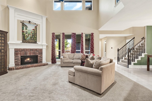 living room featuring a brick fireplace, tile patterned floors, and a towering ceiling