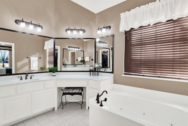 bathroom with vanity, tile patterned flooring, and a bathing tub