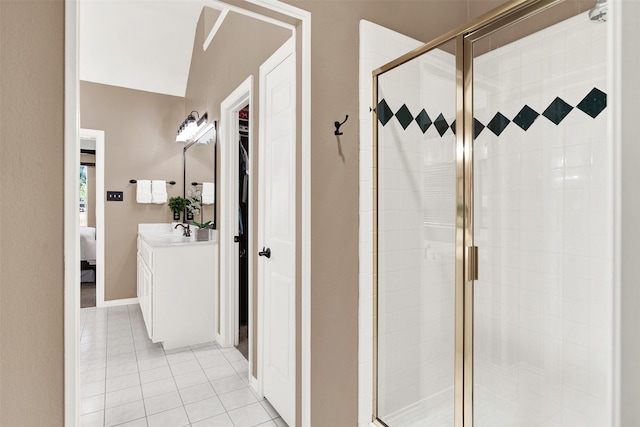 bathroom featuring a shower with shower door, tile patterned floors, and vanity