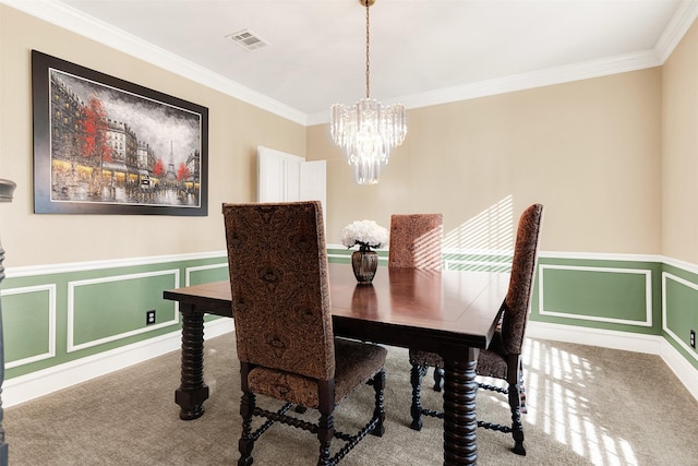 dining room featuring carpet, ornamental molding, and a chandelier