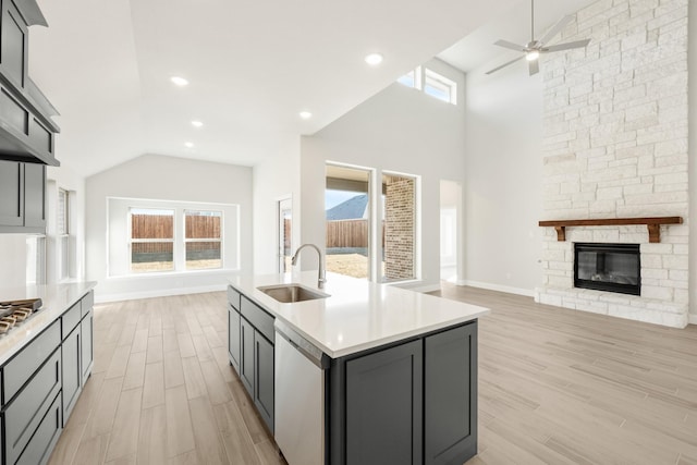 175 Creekside Dr, Sanger, TX 76266 - kitchen with open floor plan, light countertops, stainless steel appliances, a sink, and light wood finished floors