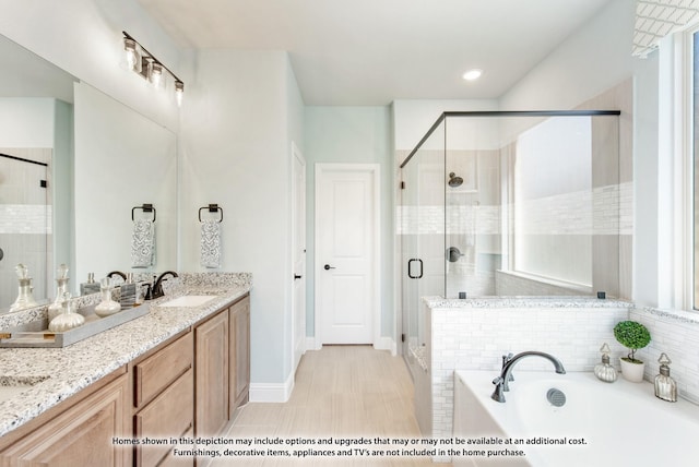 bathroom featuring plus walk in shower, tile patterned floors, and vanity