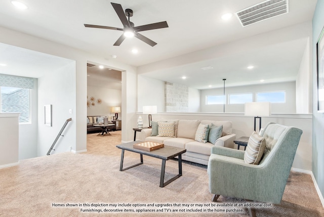 living room with light carpet and ceiling fan