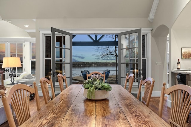 dining area with wood-type flooring and french doors