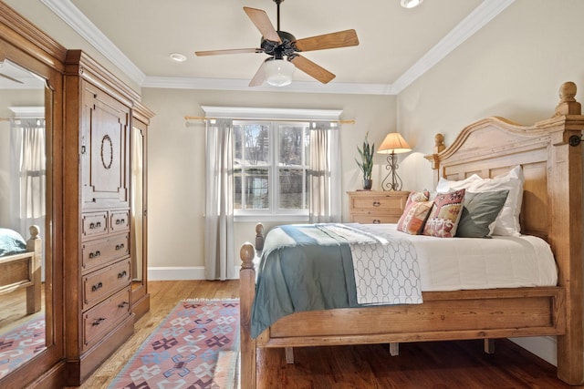 bedroom featuring light wood-type flooring, ceiling fan, and ornamental molding