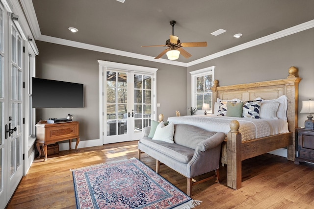 bedroom featuring ceiling fan, hardwood / wood-style floors, ornamental molding, and french doors