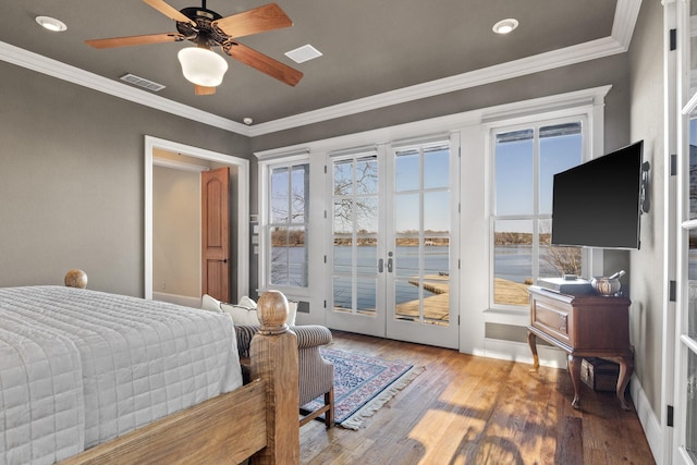 bedroom featuring hardwood / wood-style floors, french doors, access to outside, ceiling fan, and crown molding