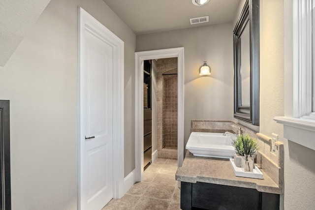 bathroom featuring sink, tile patterned flooring, and shower with separate bathtub