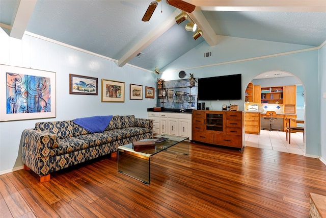 living room with ceiling fan, hardwood / wood-style floors, beam ceiling, and a textured ceiling