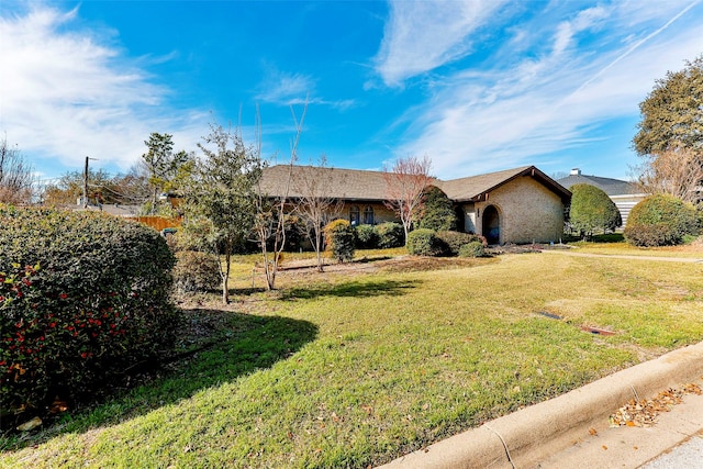 ranch-style home with a front lawn