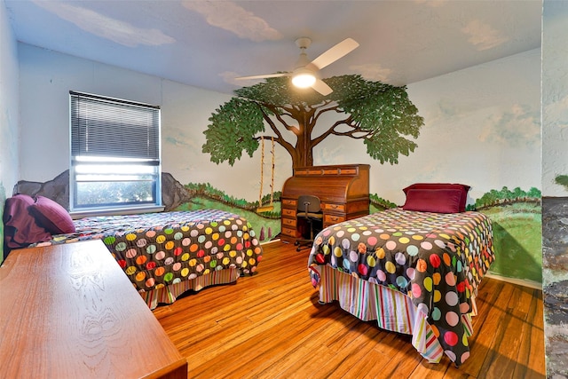 bedroom featuring ceiling fan and hardwood / wood-style floors