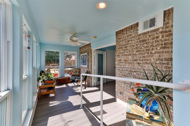 sunroom featuring ceiling fan