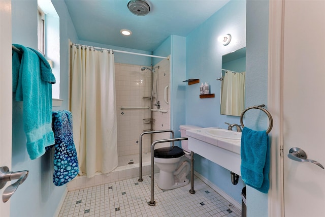 bathroom with sink, toilet, a shower with curtain, and tile patterned flooring