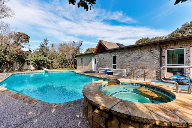 view of swimming pool with an in ground hot tub