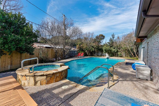 view of swimming pool with an in ground hot tub and a diving board