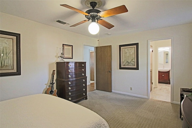 carpeted bedroom with ceiling fan, sink, and ensuite bathroom