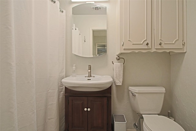 bathroom featuring toilet and vanity