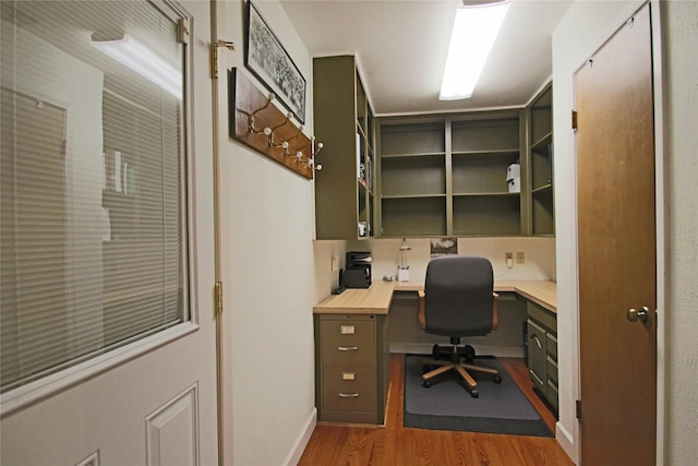 home office with light hardwood / wood-style floors