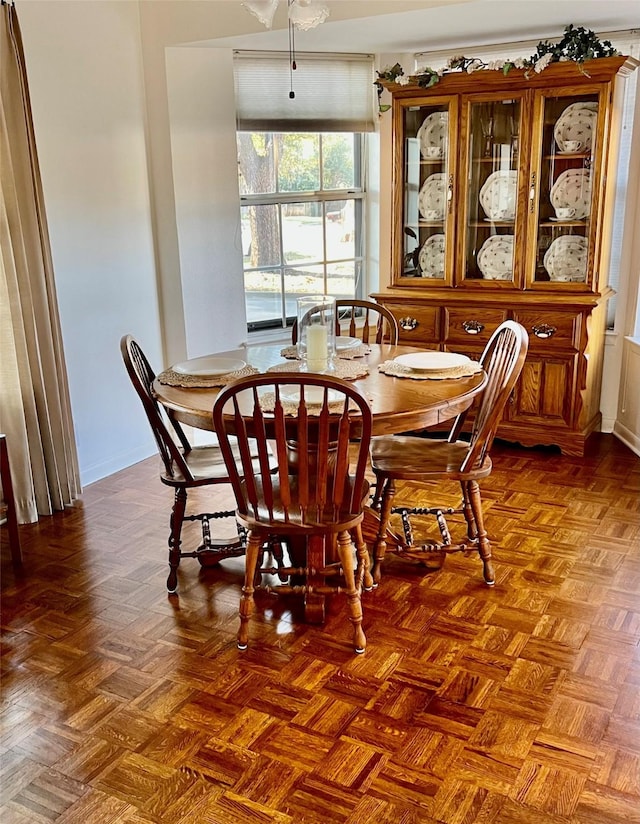 dining area featuring parquet floors