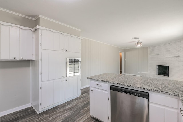 kitchen with a brick fireplace, appliances with stainless steel finishes, dark hardwood / wood-style flooring, ornamental molding, and white cabinets